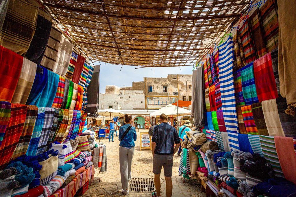 Couple walks through a market in the Middle East.