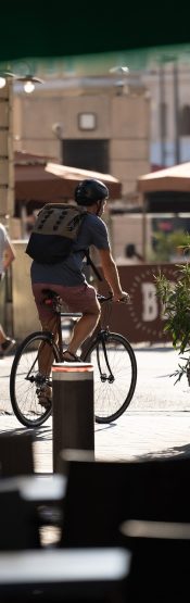 Young missionary biking while exploring a city overseas.